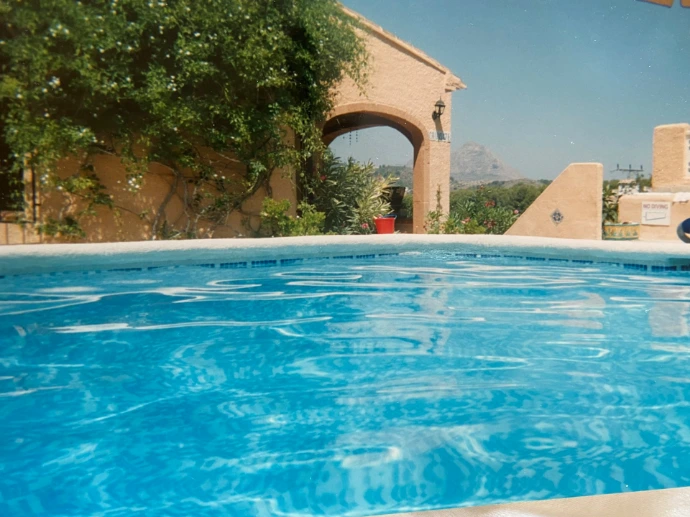 a blue swimming pool with a view of a building